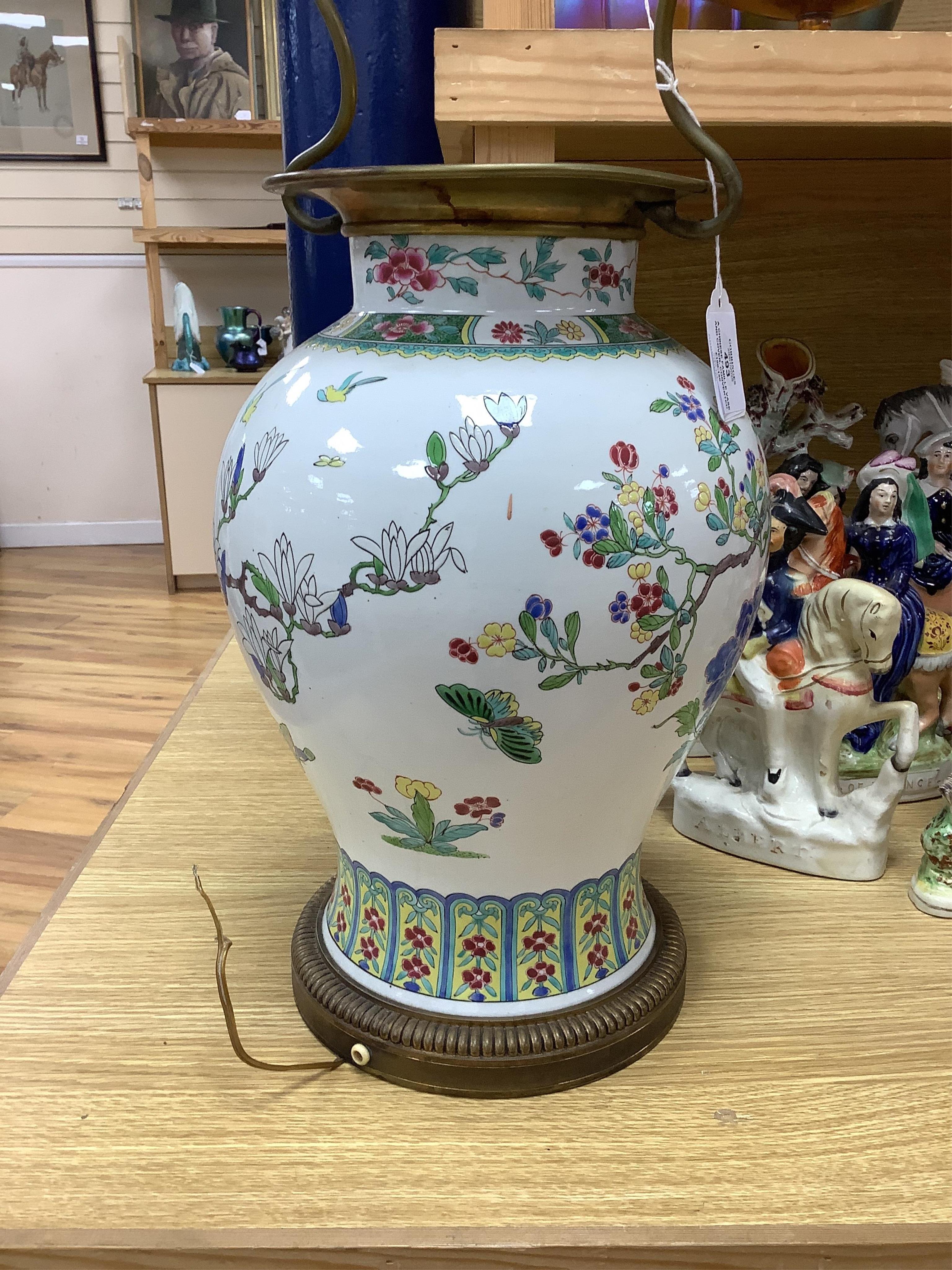 A Chinese famille vase and cover, converted to a two light lamp, 75cms high including fitting. Condition - fair to good